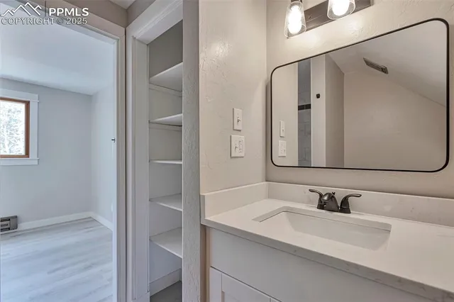 a bathroom with a double vanity sink and mirror