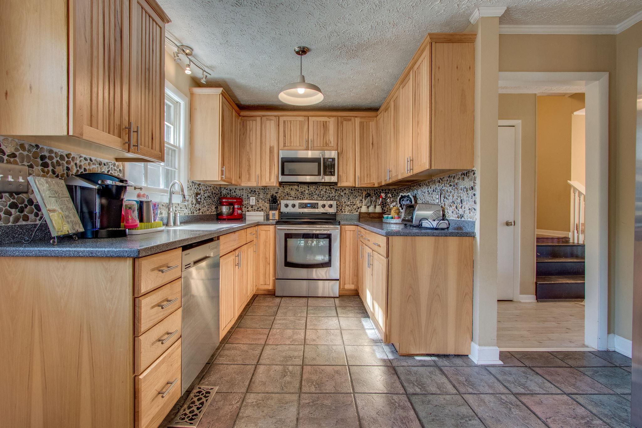 835 Beasleys Bend Road Lebanon, TN 37087 - Photo 13 of 33 a kitchen with stainless steel appliances granite countertop a stove a sink and a refrigerator