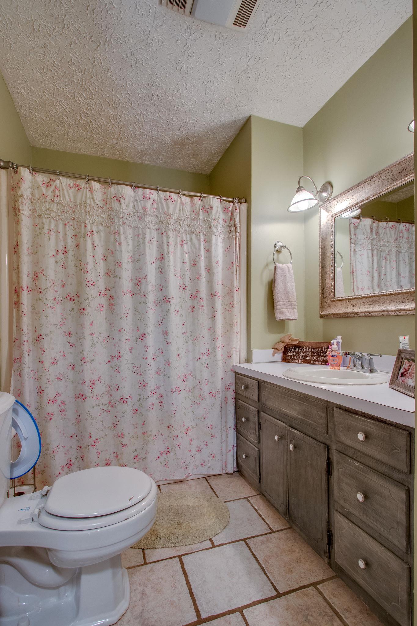 835 Beasleys Bend Road Lebanon, TN 37087 - Photo 23 of 33 a bathroom with a granite countertop toilet sink and mirror