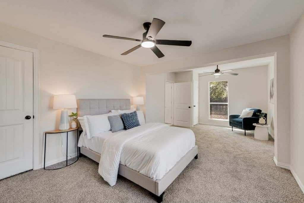1802 Gus Thomasson Road Dallas, TX 75228 - Photo 11 of 17 a spacious bedroom with a bed and ceiling fan
