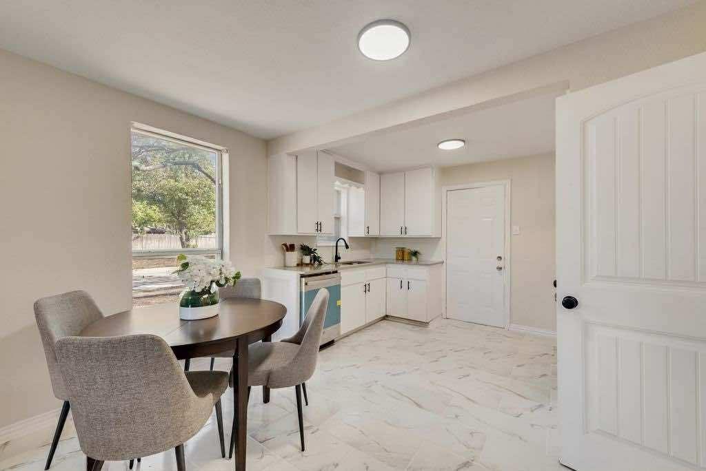 1802 Gus Thomasson Road Dallas, TX 75228 - Photo 5 of 17 a kitchen with a dining table chairs and white cabinets