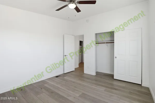 a kitchen with stainless steel appliances granite countertop a stove top oven a refrigerator a sink dishwasher and wooden cabinets with wooden floor