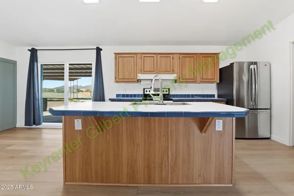 a kitchen with stainless steel appliances granite countertop a refrigerator stove and sink