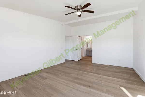 a bathroom with a double vanity sink a toilet a mirror and bathtub