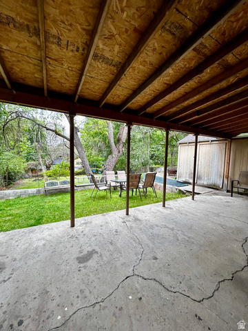 1931 Harrison Boulevard Ogden, UT 84401 - Photo 16 of 21 Covered patio space featuring an exposed plywood ceiling, supporting columns, and a concrete slab