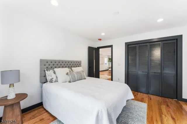 a bedroom with a bed and a night stand