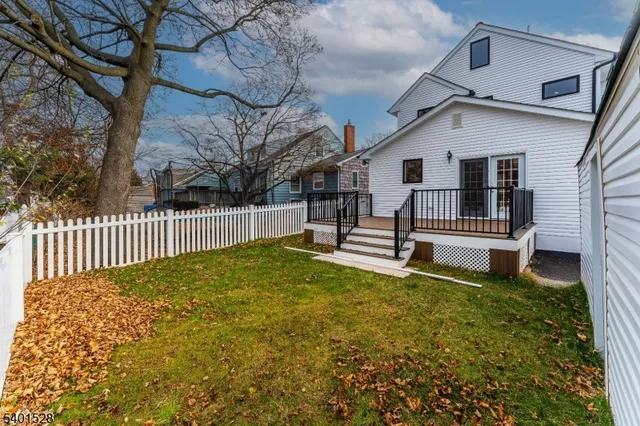 a view of a house with a wooden fence