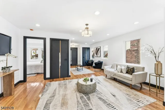a living room with furniture and a chandelier