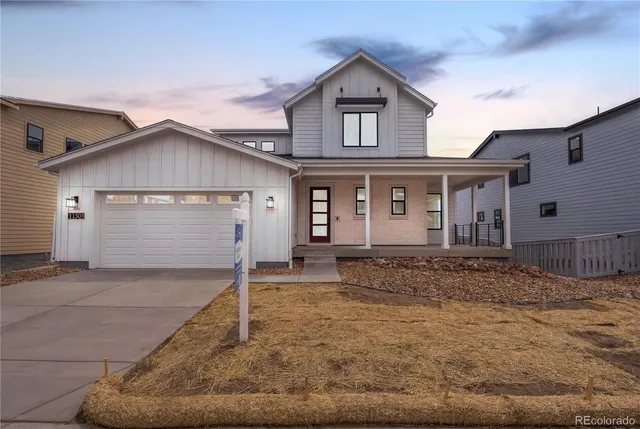 a view of a house with a yard and garage
