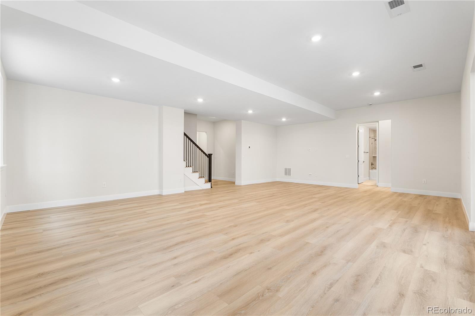 11303 Tenor Trail Lone Tree, CO 80134 - Photo 19 of 49 a view of an empty room with wooden floor