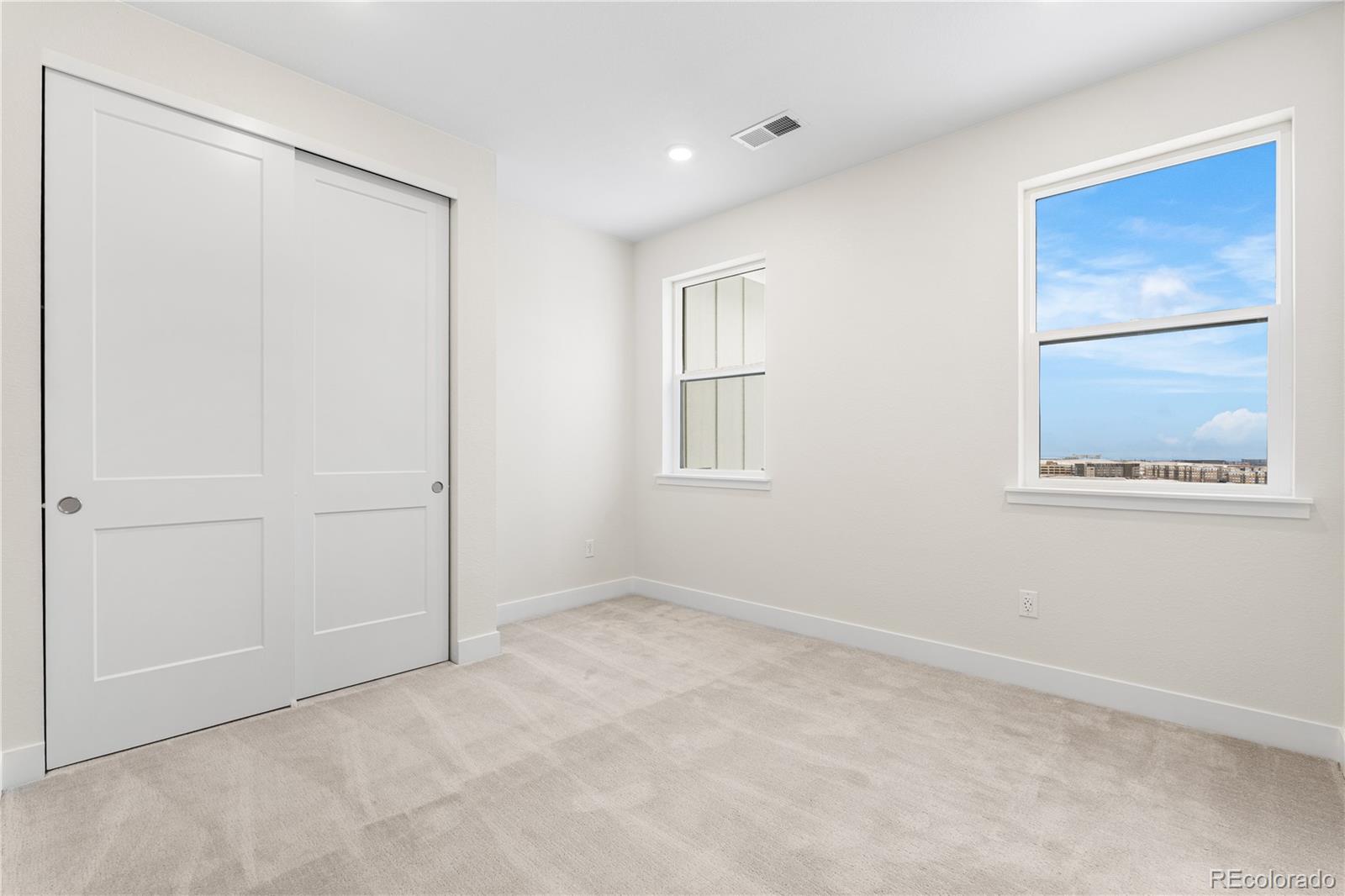11303 Tenor Trail Lone Tree, CO 80134 - Photo 23 of 49 an empty room with windows and closet