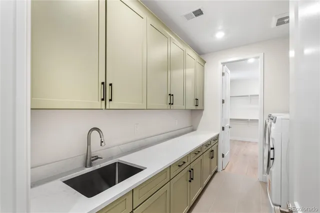 a kitchen with stainless steel appliances a sink stove and cabinets