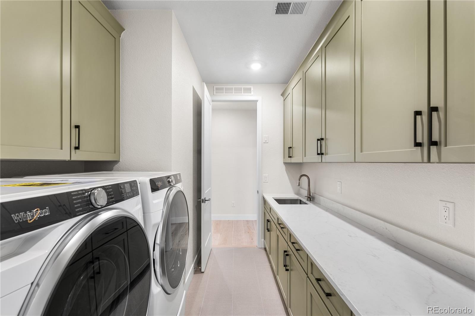 11303 Tenor Trail Lone Tree, CO 80134 - Photo 27 of 49 a utility room with dryer and washer