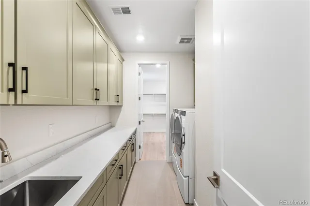 a hallway with a sink and a mirror