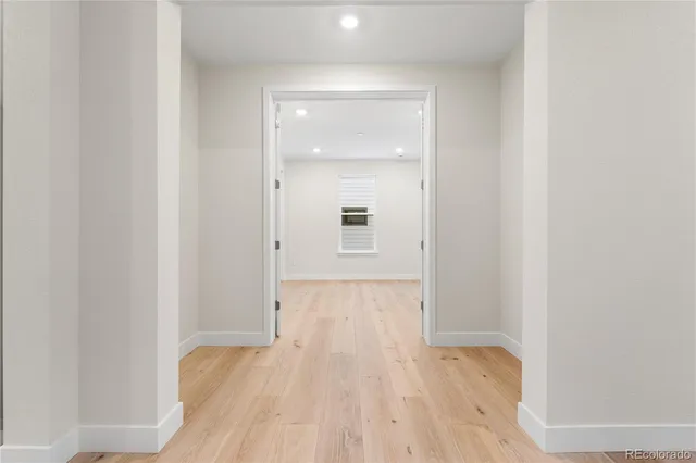 a view of a hallway with wooden floor