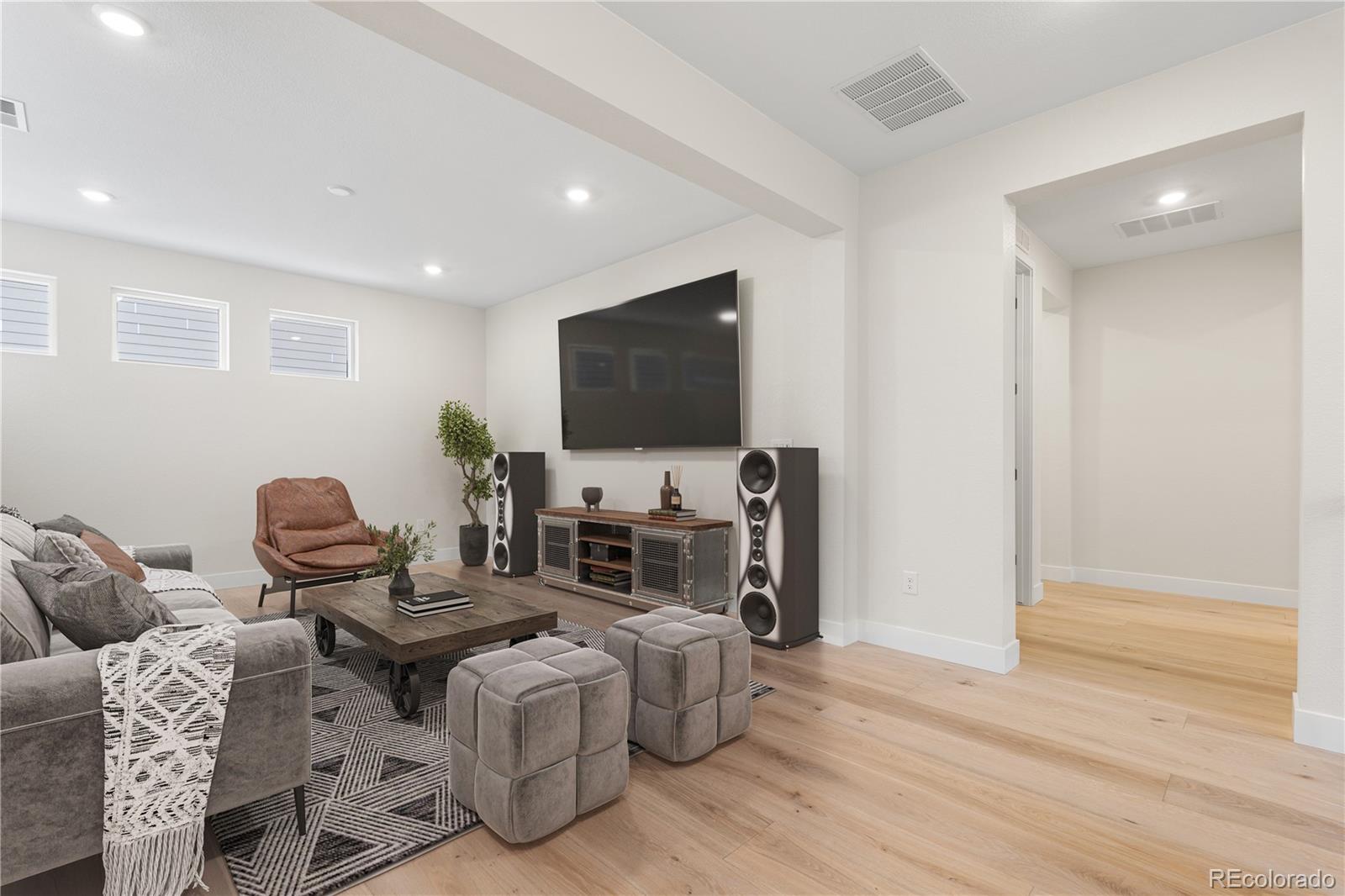11303 Tenor Trail Lone Tree, CO 80134 - Photo 30 of 49 a living room with furniture and a flat screen tv