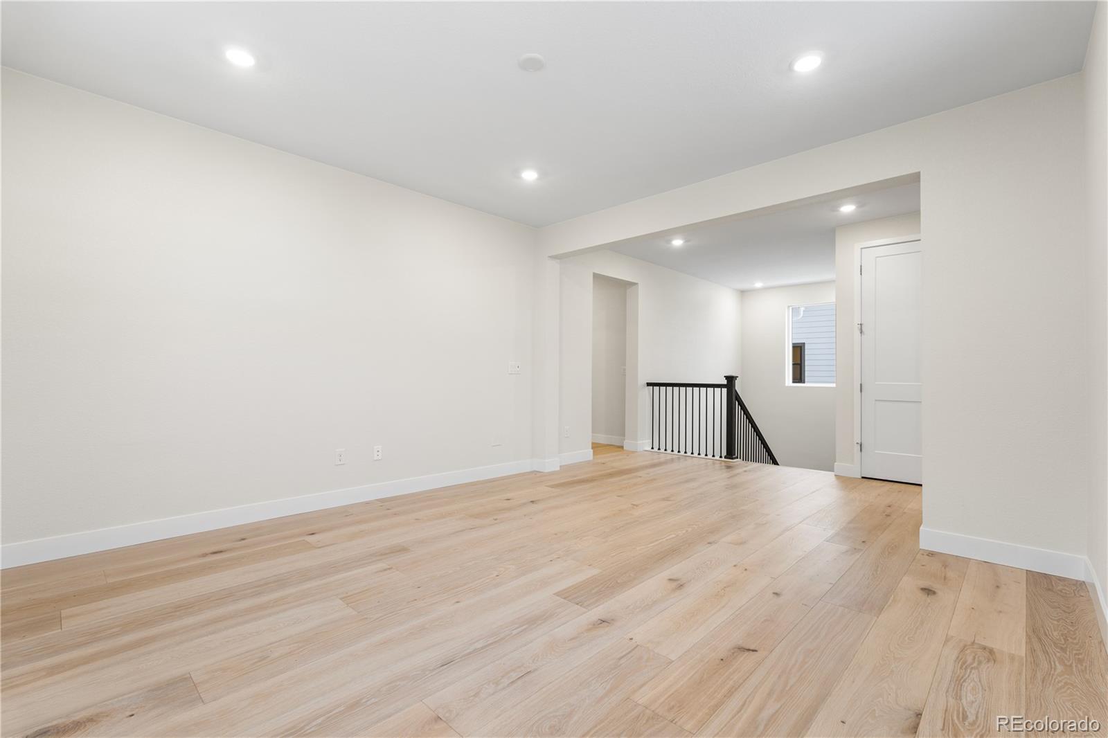 11303 Tenor Trail Lone Tree, CO 80134 - Photo 32 of 49 a view of an empty room with wooden floor