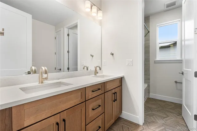 a bathroom with a double vanity sink a mirror and a