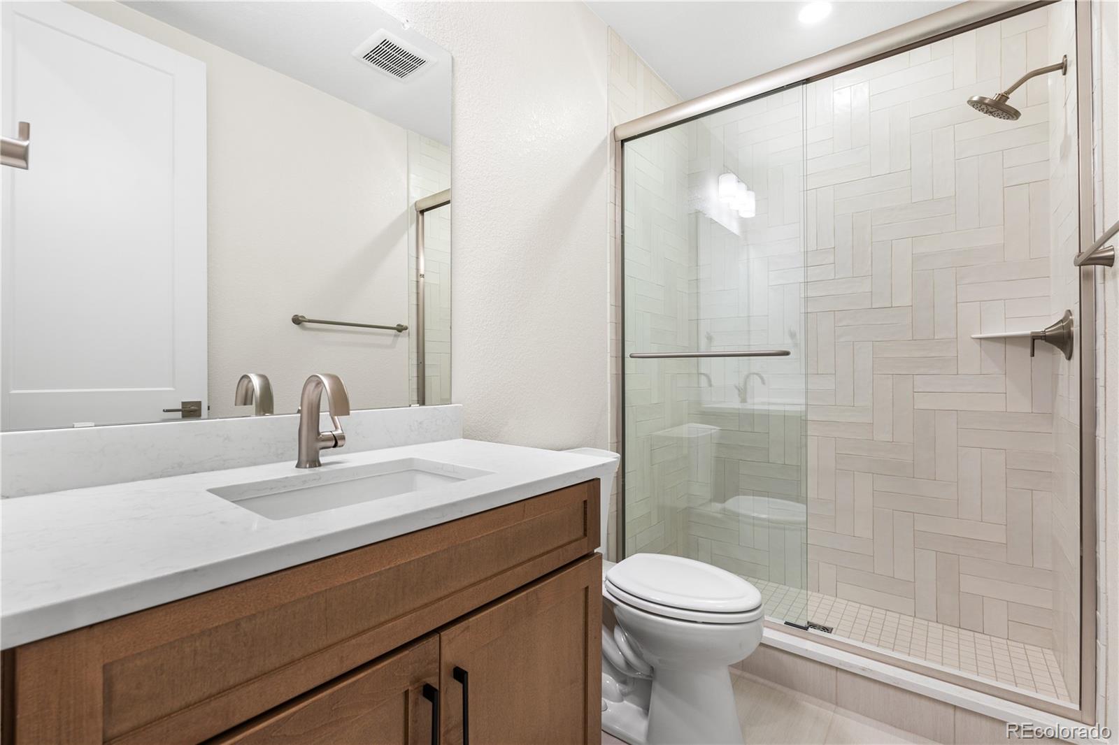 11303 Tenor Trail Lone Tree, CO 80134 - Photo 39 of 49 a bathroom with a sink a toilet and shower