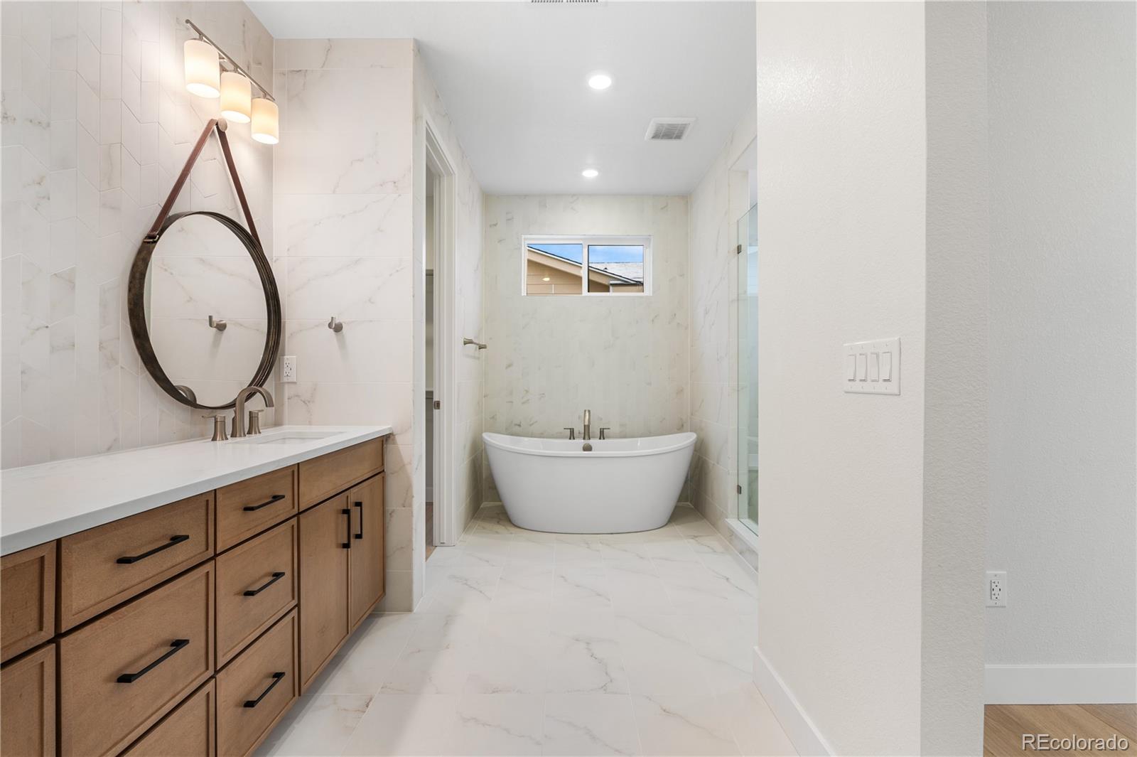 11303 Tenor Trail Lone Tree, CO 80134 - Photo 41 of 49 a bathroom with a double vanity sink mirror and bathtub