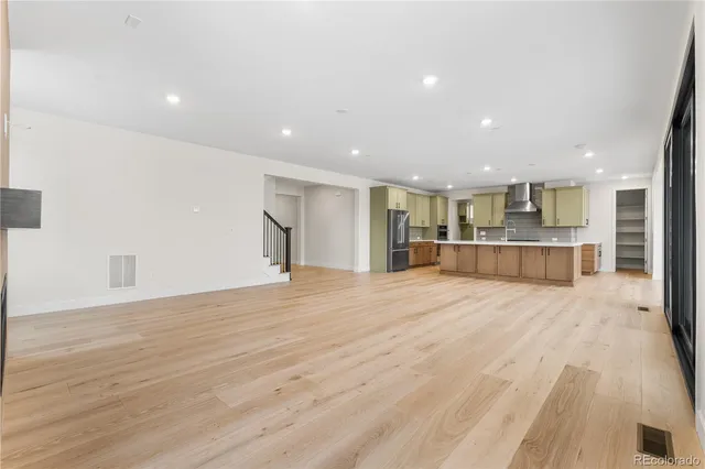 a view of kitchen with refrigerator and wooden floor