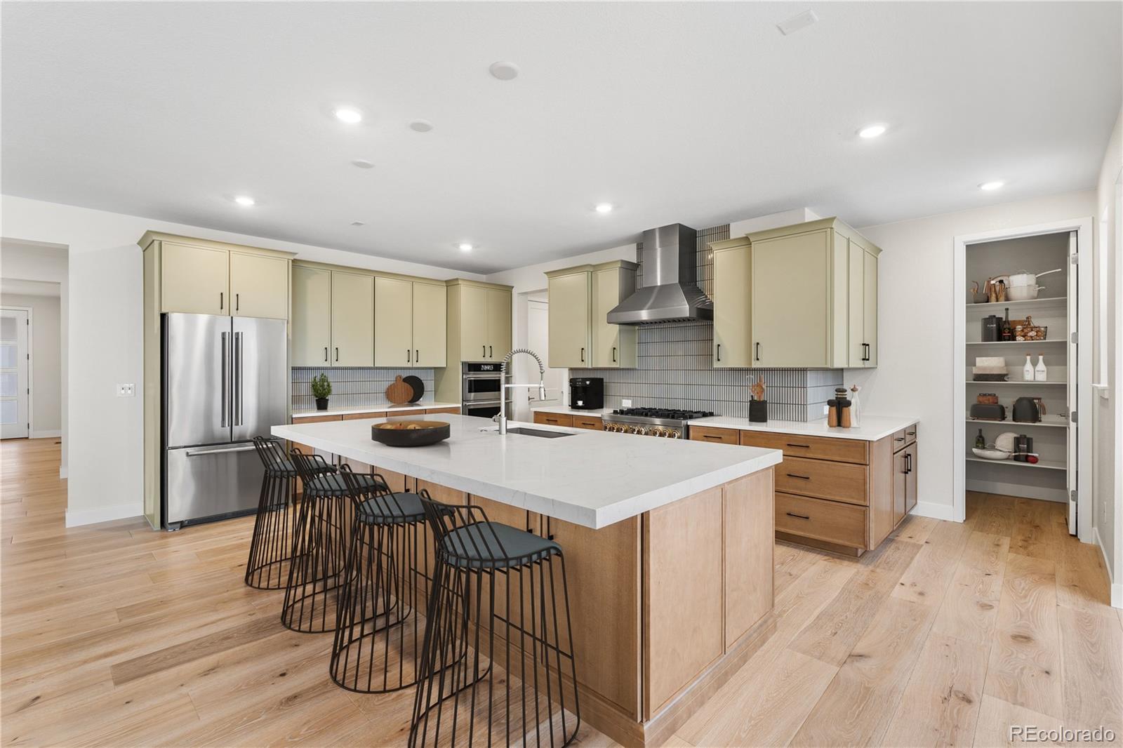 11303 Tenor Trail Lone Tree, CO 80134 - Photo 8 of 49 a kitchen with a sink a counter top space stainless steel appliances and cabinets