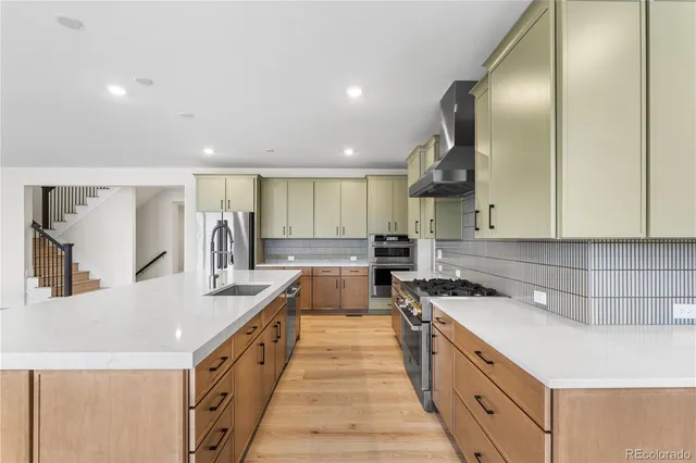 a kitchen with counter top space a sink and appliances