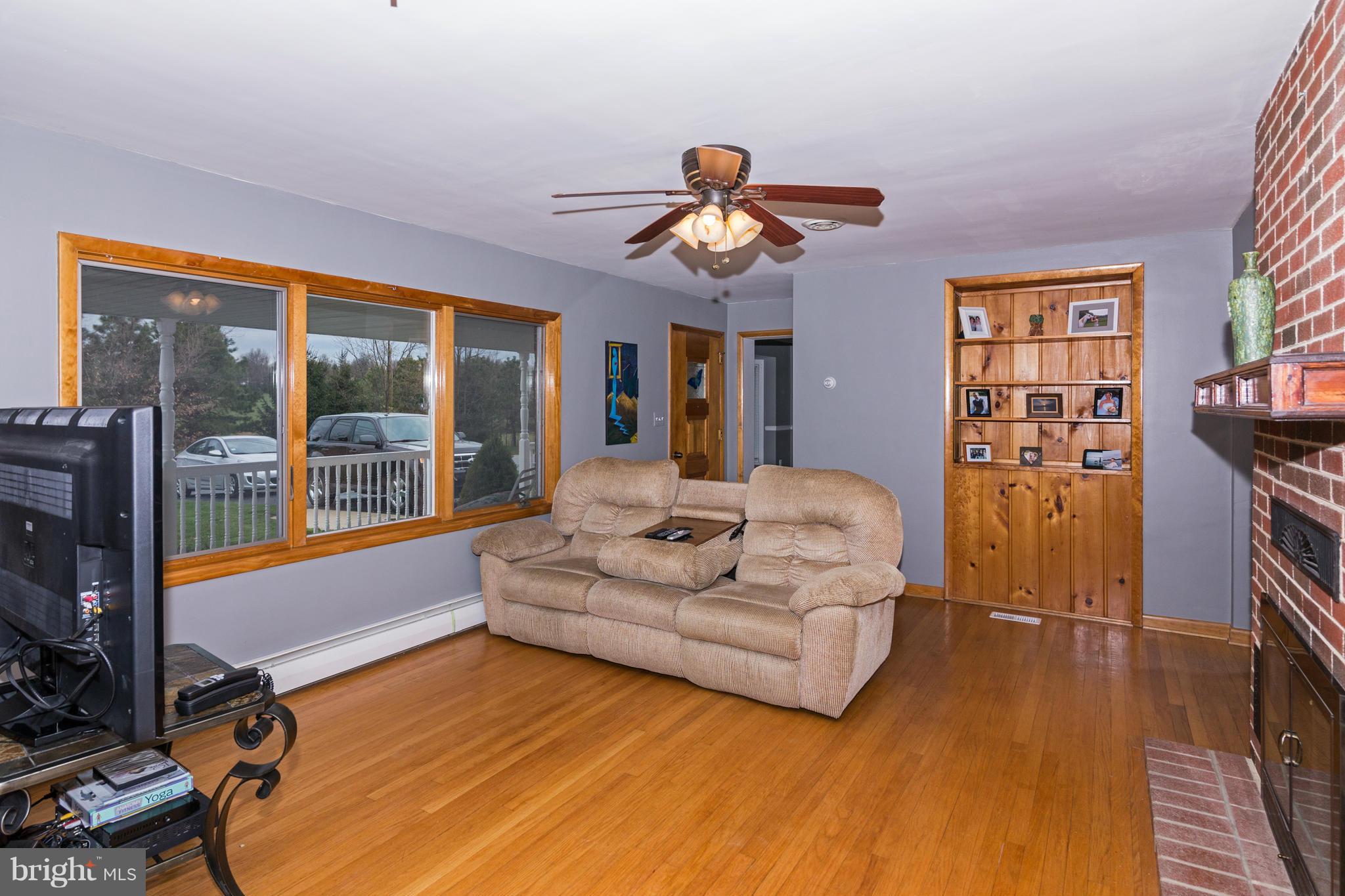 4201 Buffalo Road Mount Airy, MD 21771 - Photo 12 of 29 a living room with furniture flat screen tv and a large window