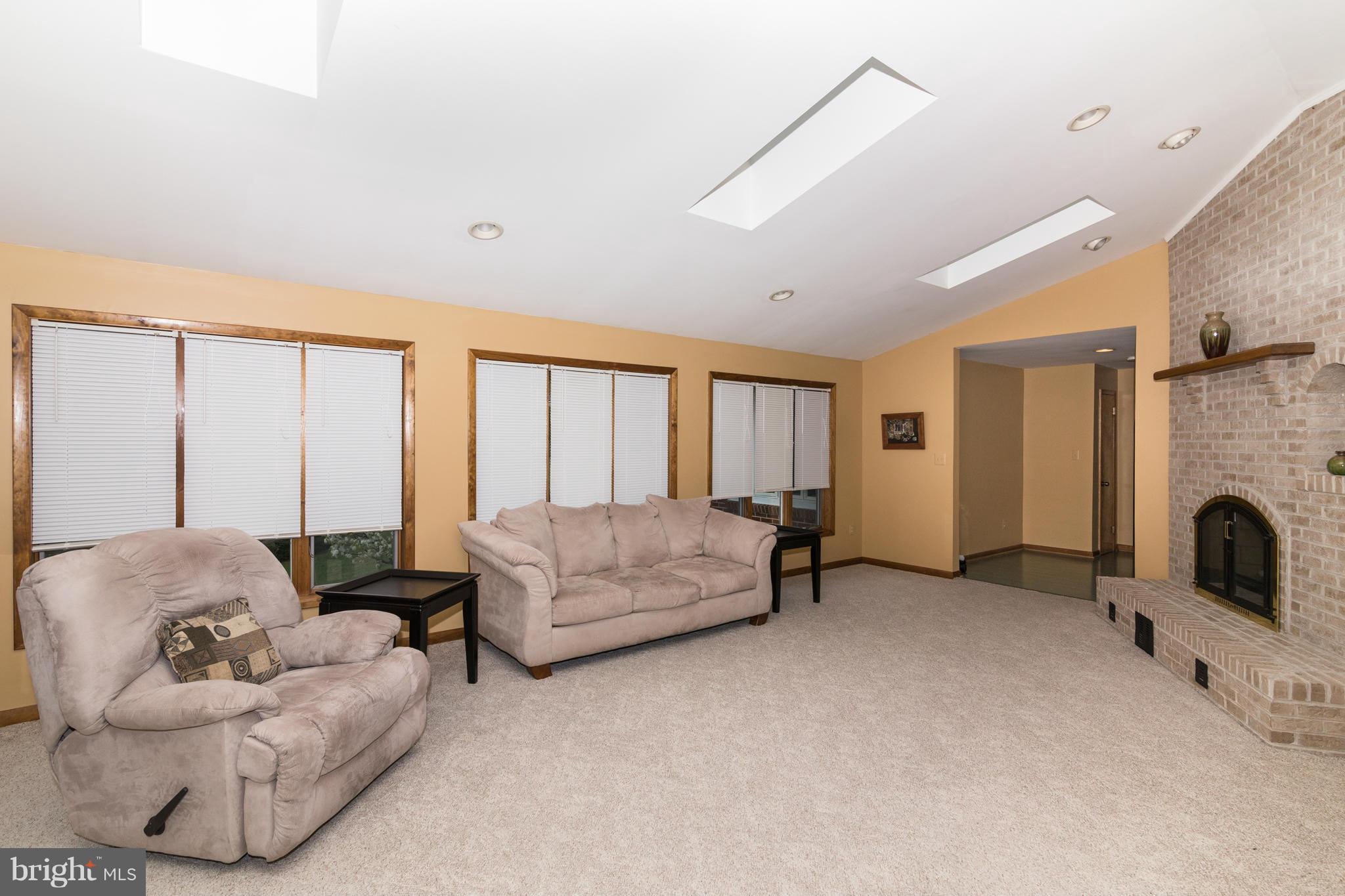 4201 Buffalo Road Mount Airy, MD 21771 - Photo 15 of 29 a living room with furniture and a fireplace
