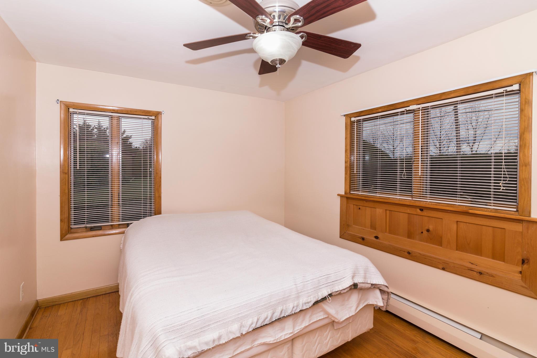 4201 Buffalo Road Mount Airy, MD 21771 - Photo 18 of 29 a bedroom with a large bed and a large window