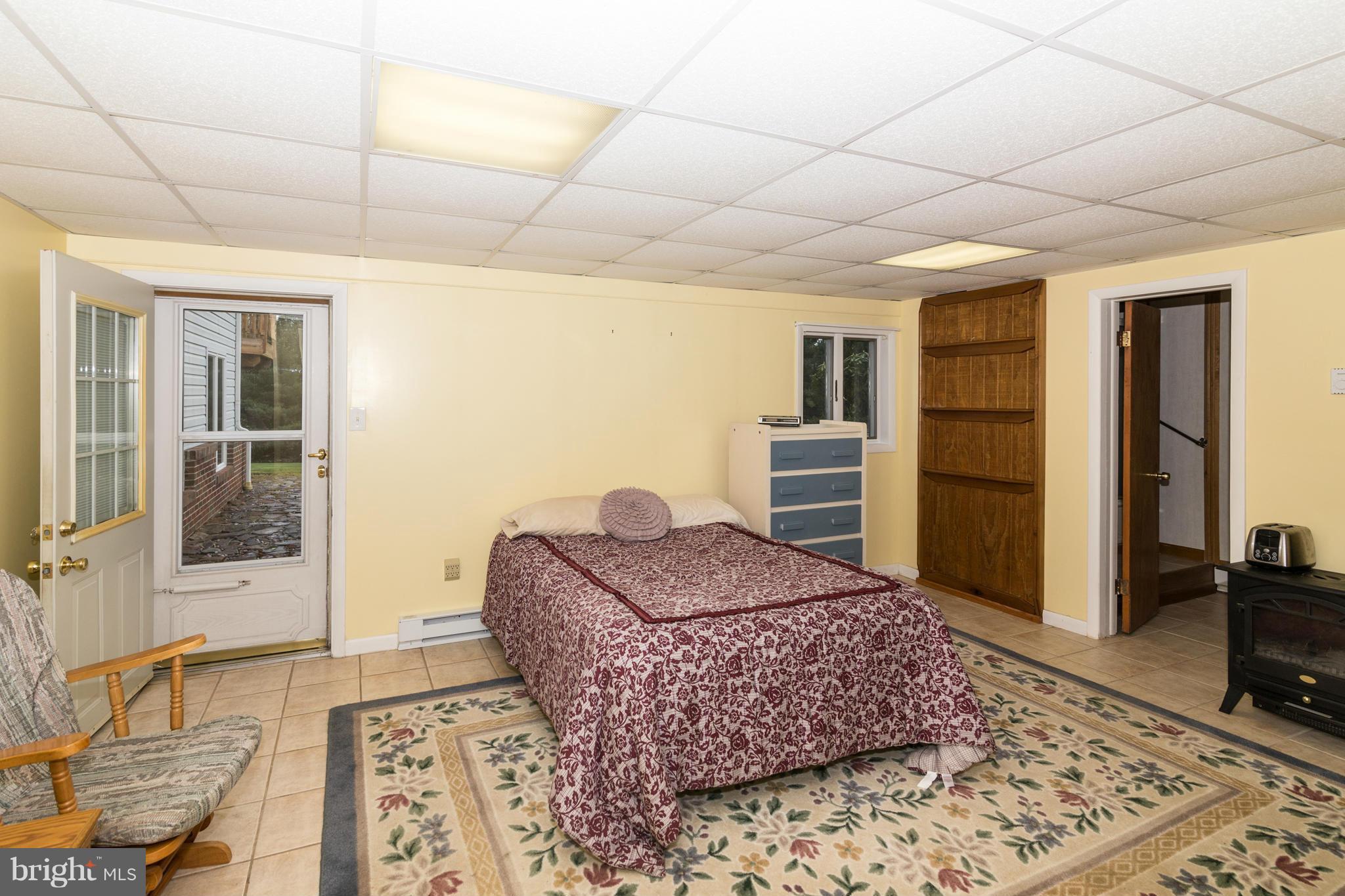 4201 Buffalo Road Mount Airy, MD 21771 - Photo 23 of 29 a living room with a couch and dresser with wooden floor