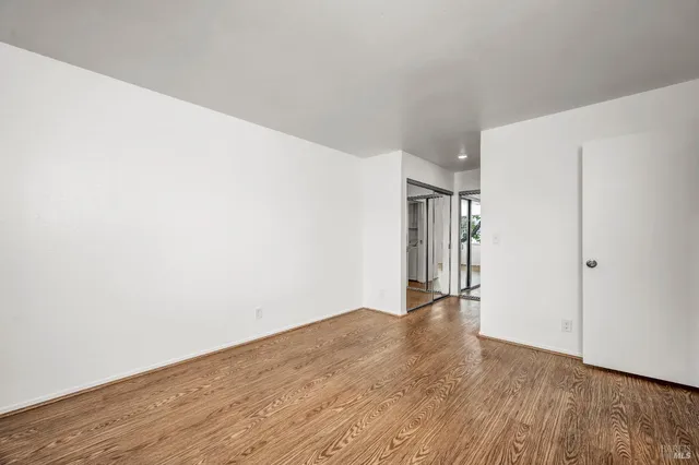 a view of hallway with wooden floor