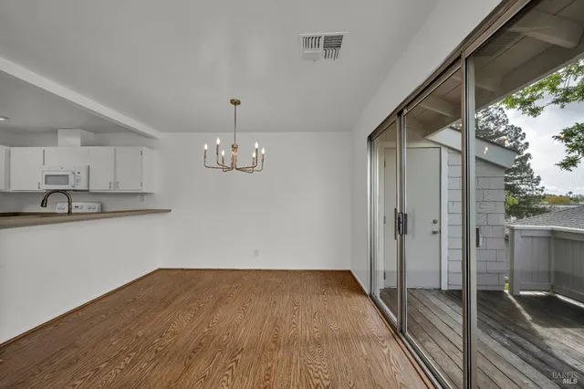 a view of a room with wooden floor and window