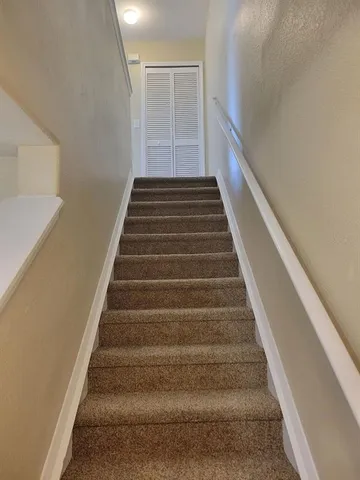 an empty room with a window and a ceiling fan