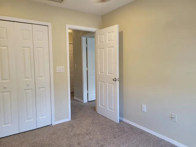 an empty room with closet area