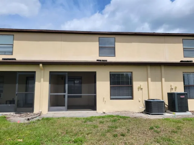 a large house with a big yard and large trees