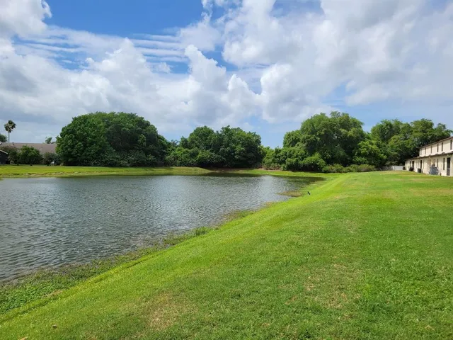 a view of a lake with houses in the background
