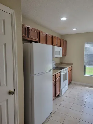 a white refrigerator freezer sitting inside of a kitchen