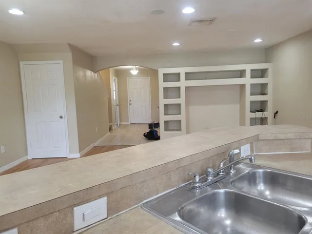 a kitchen with a sink and a mirror