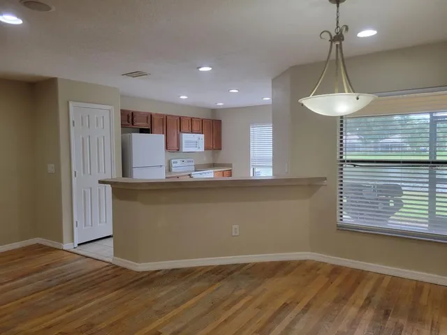 a kitchen with kitchen island a counter top space a sink and appliances