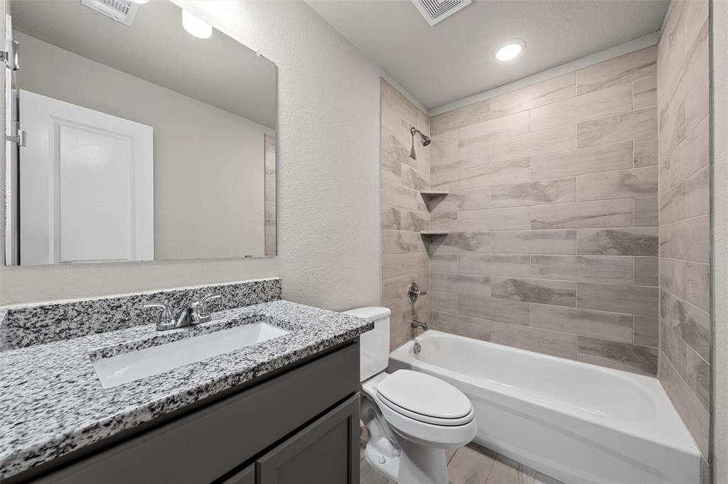3208 Dottavio Road Lorena, TX 76655 - Photo 20 of 31 Bathroom featuring a single vanity with a granite-style countertop, undermount sink, and chrome-finish faucet