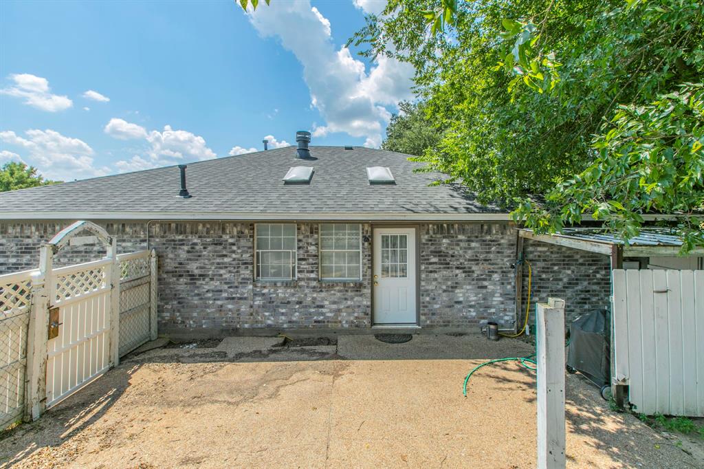 1936 Post Oak Drive Waco, TX 76705 - Photo 24 of 33 Rear view of house featuring roof with shingles and brick siding