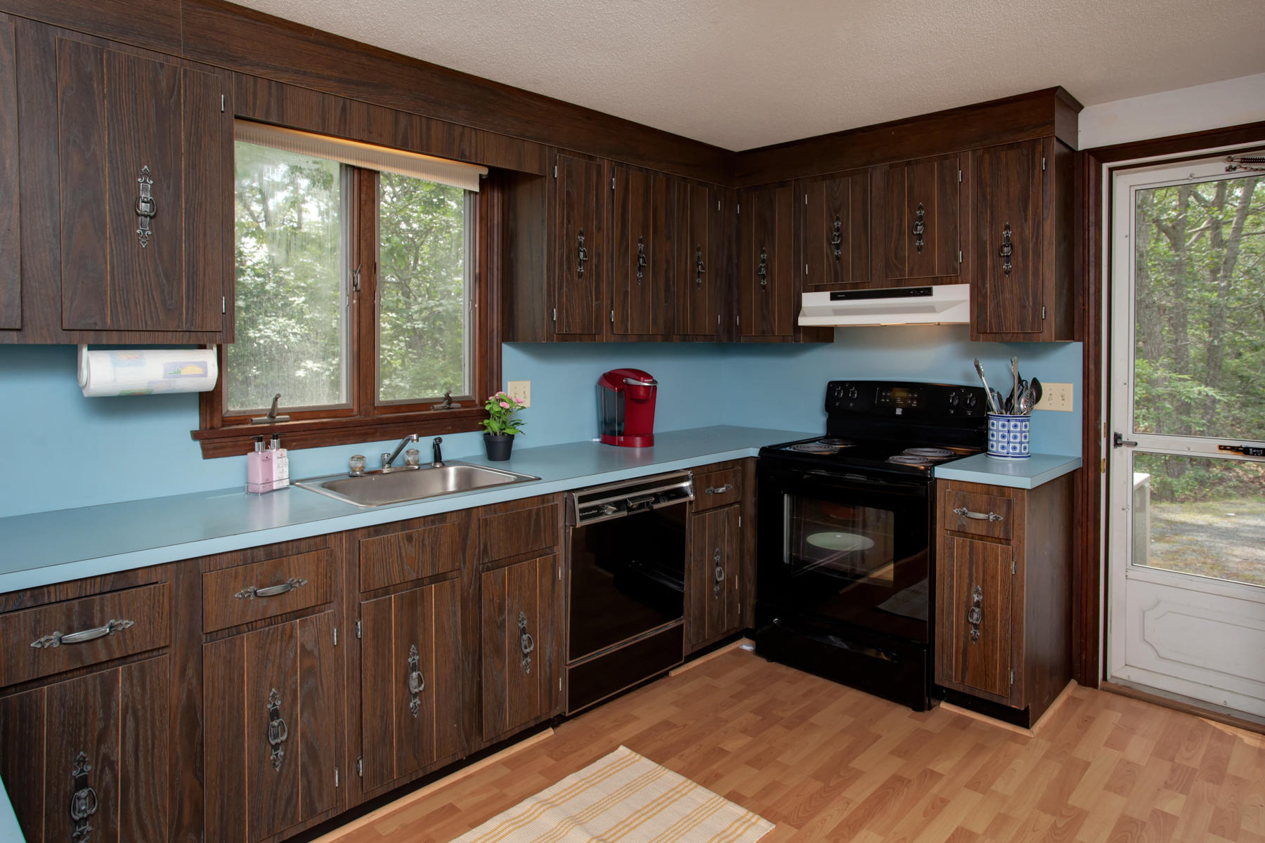21 Oak Ridge Road East Sandwich, MA 02537 - Photo 14 of 31 a kitchen with stainless steel appliances granite countertop a stove a sink dishwasher and a microwave oven with cabinets