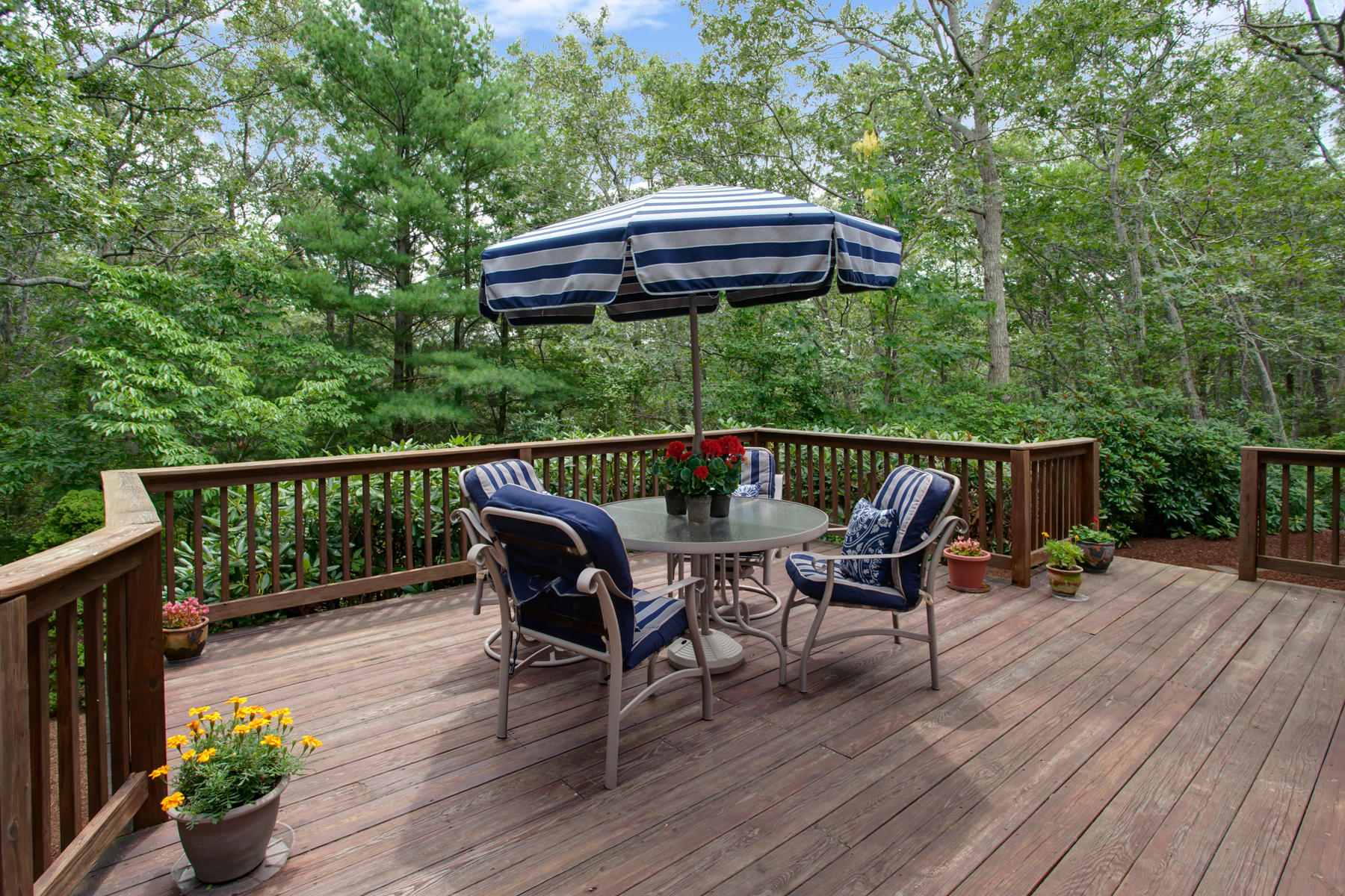 21 Oak Ridge Road East Sandwich, MA 02537 - Photo 26 of 31 a roof deck with table and chairs under an umbrella with wooden floor