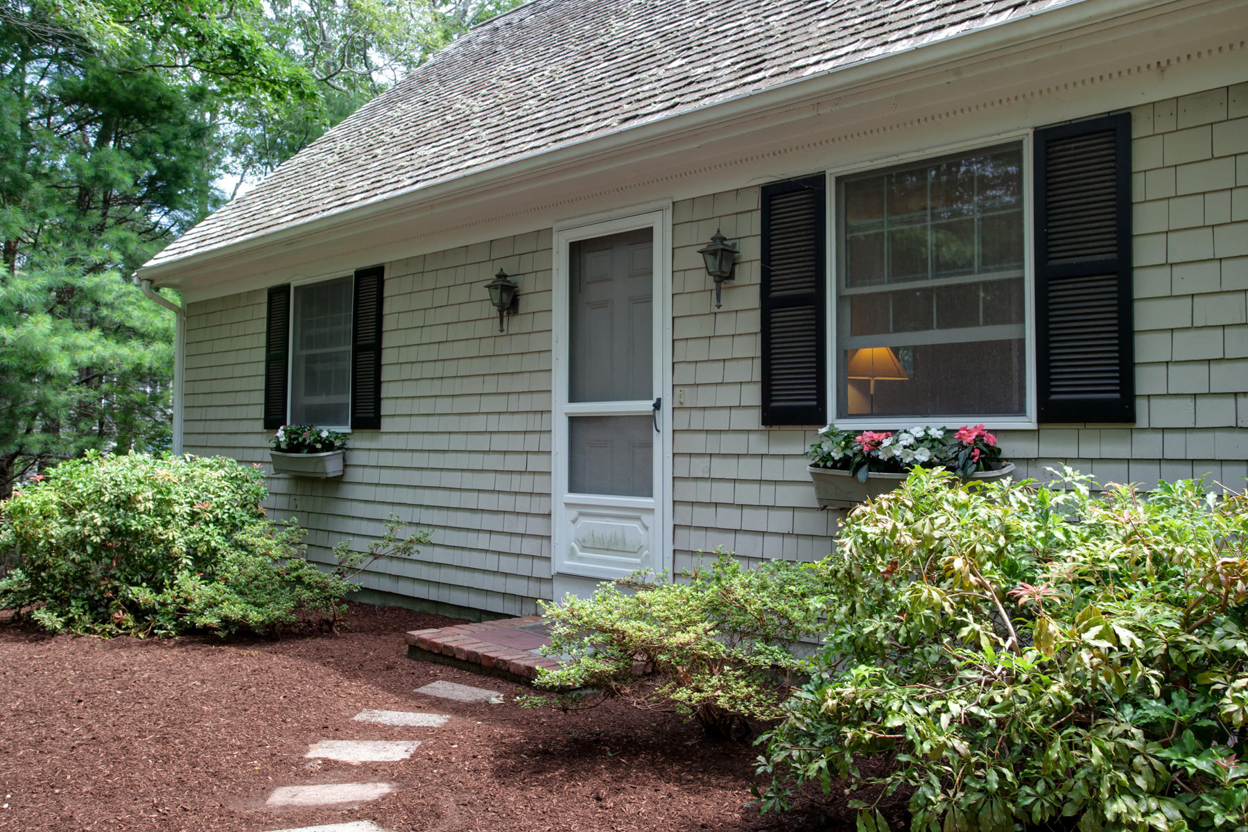 21 Oak Ridge Road East Sandwich, MA 02537 - Photo 4 of 31 a front view of a house with a yard