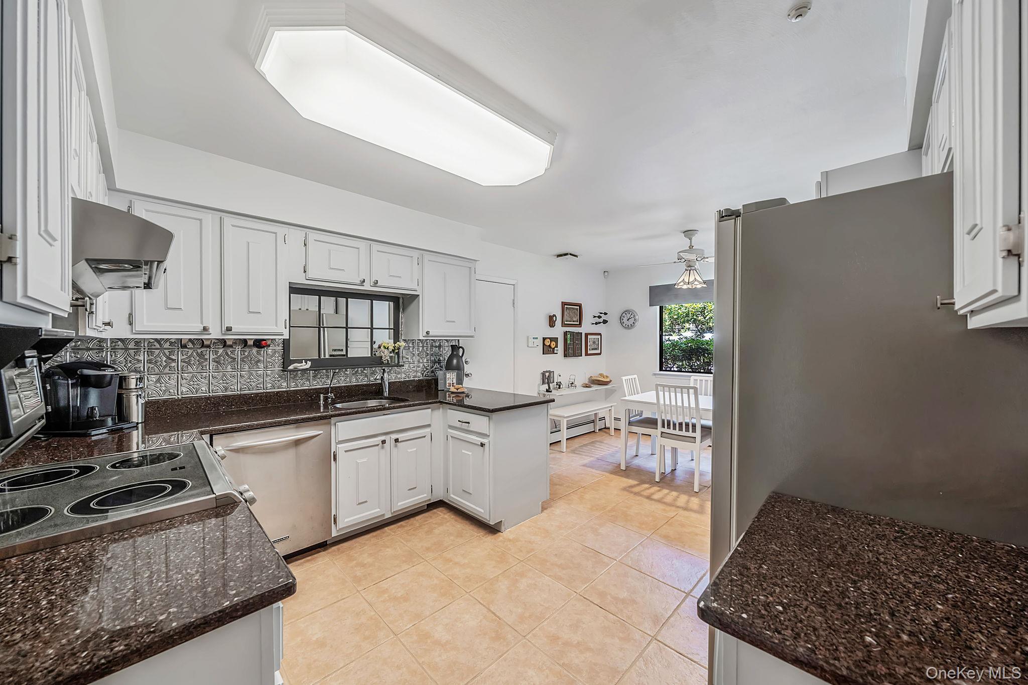 96 Fulton Boulevard Commack, NY 11725 - Photo 19 of 41 a kitchen with sink and stove