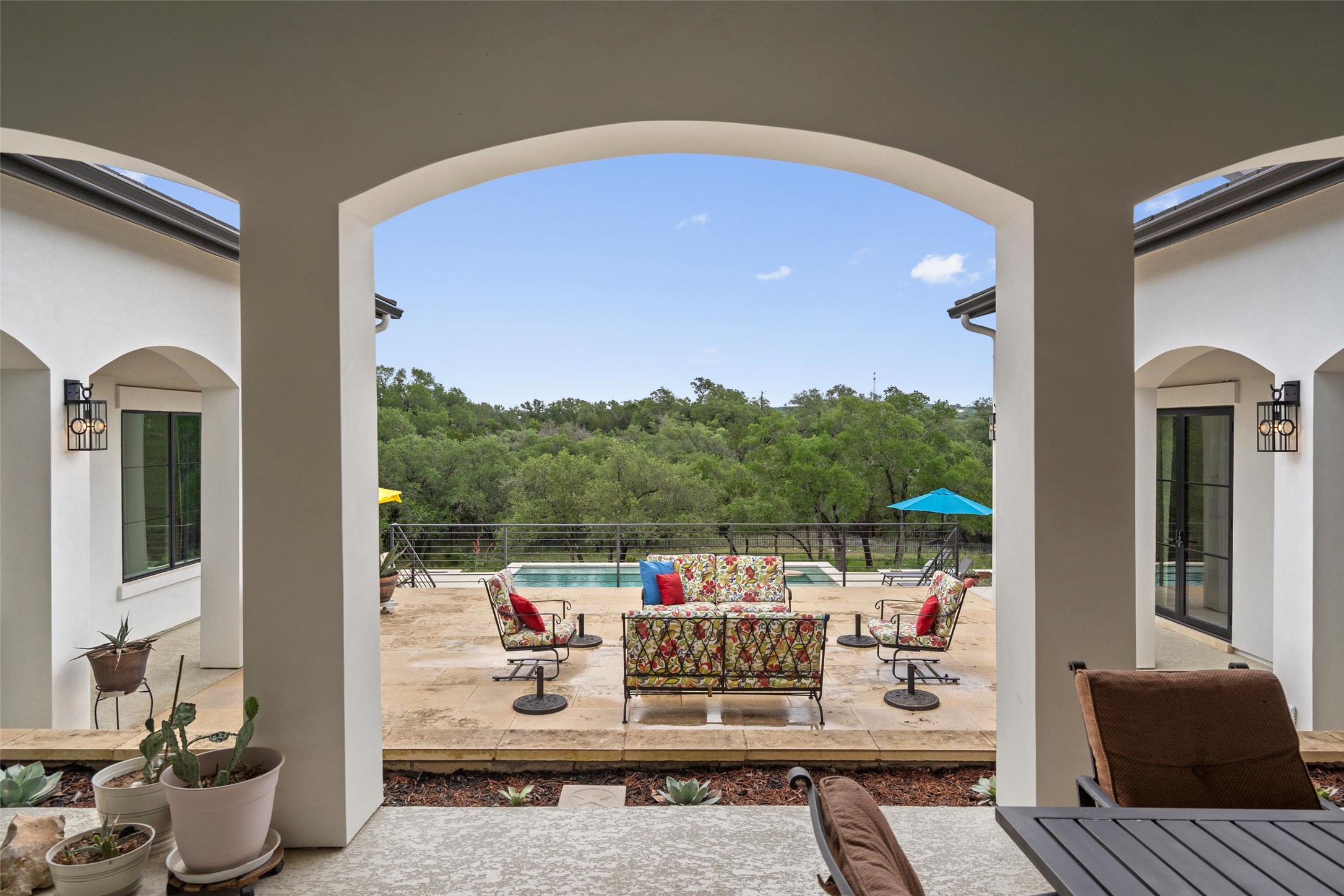 1805 Performer Road Spicewood, TX 78669 - Photo 22 of 40 Covered patio with arched entryways, overlooking a swimming pool