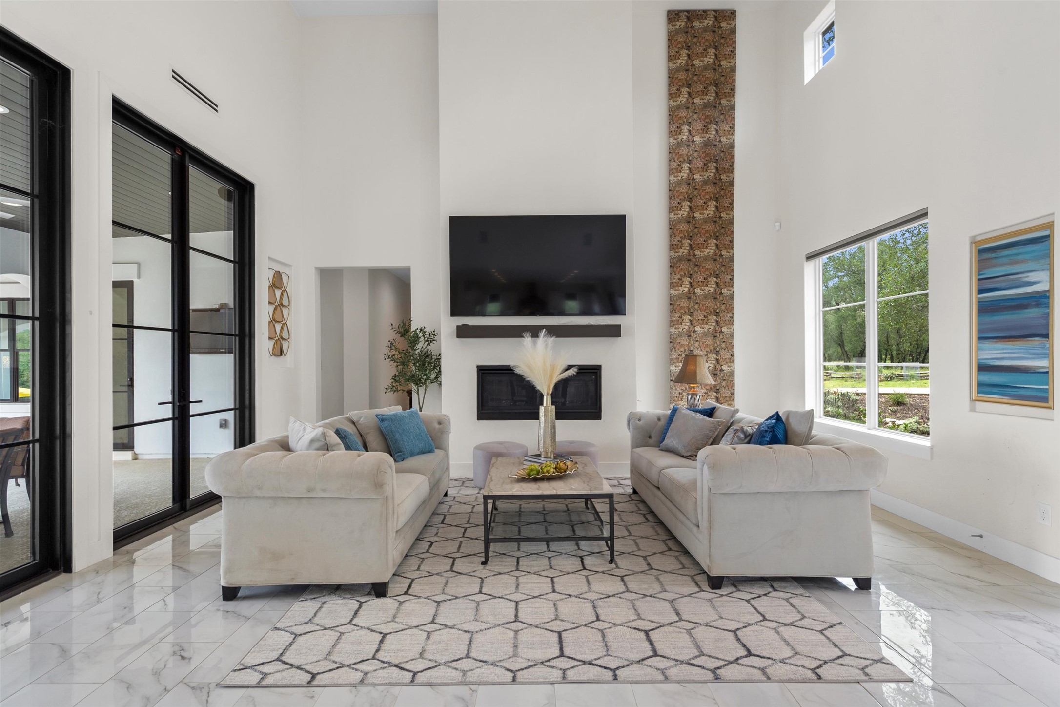 1805 Performer Road Spicewood, TX 78669 - Photo 3 of 40 The striking facade, expansive windows and elegant entry create a warm welcoming first impression into the living area.