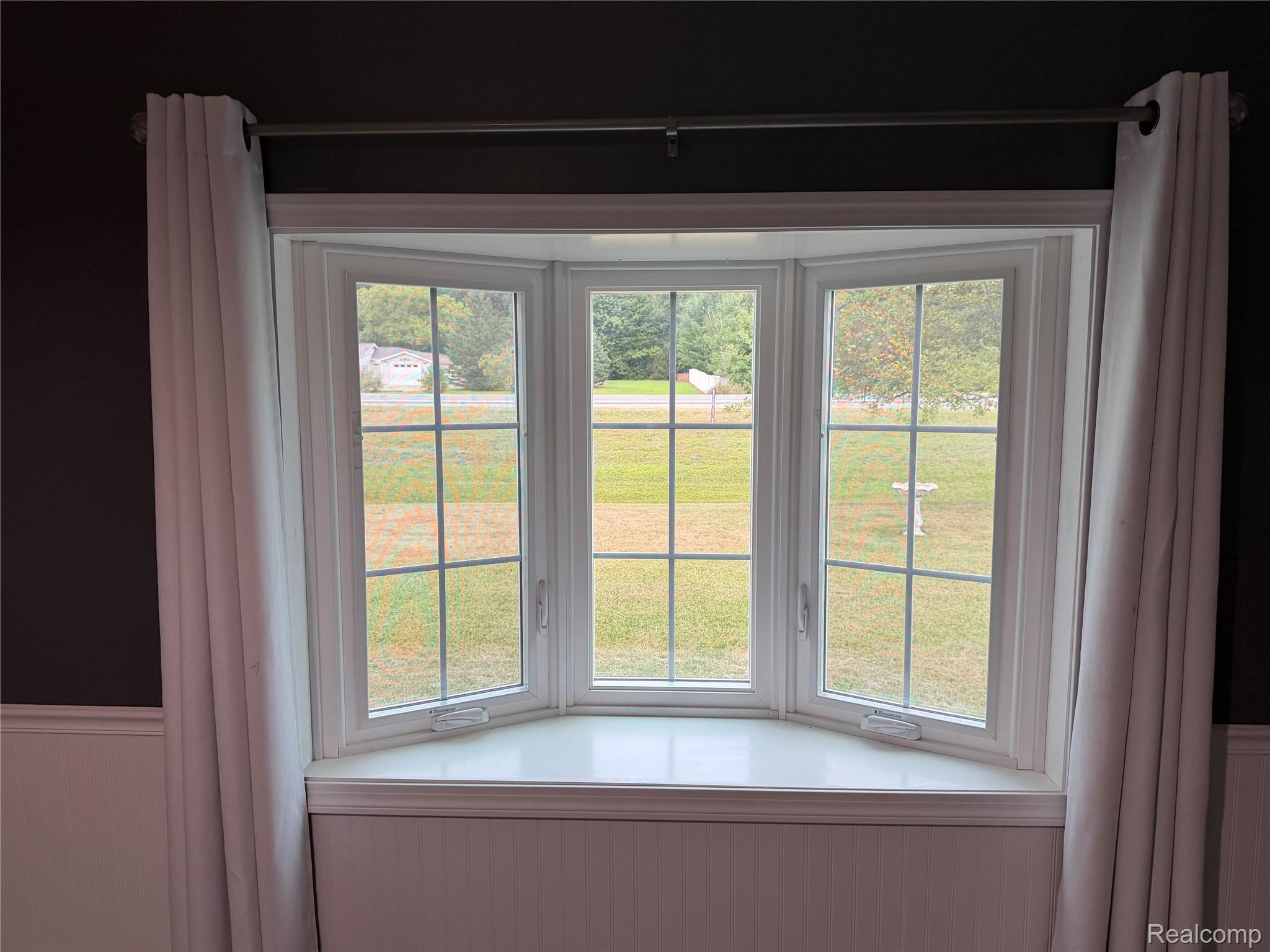 2402 Mertz Road Caro, MI 48723 - Photo 5 of 26 Bay window with white trim, gridded panes, and a built-in window sill