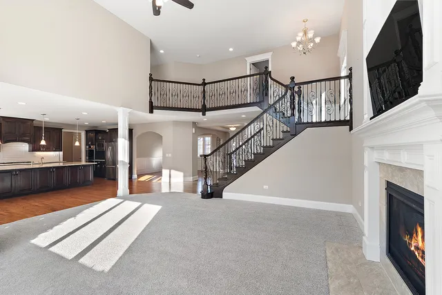 a view of an empty room with furniture and a window